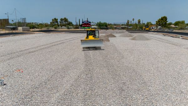 Construction equipment smoothing the field