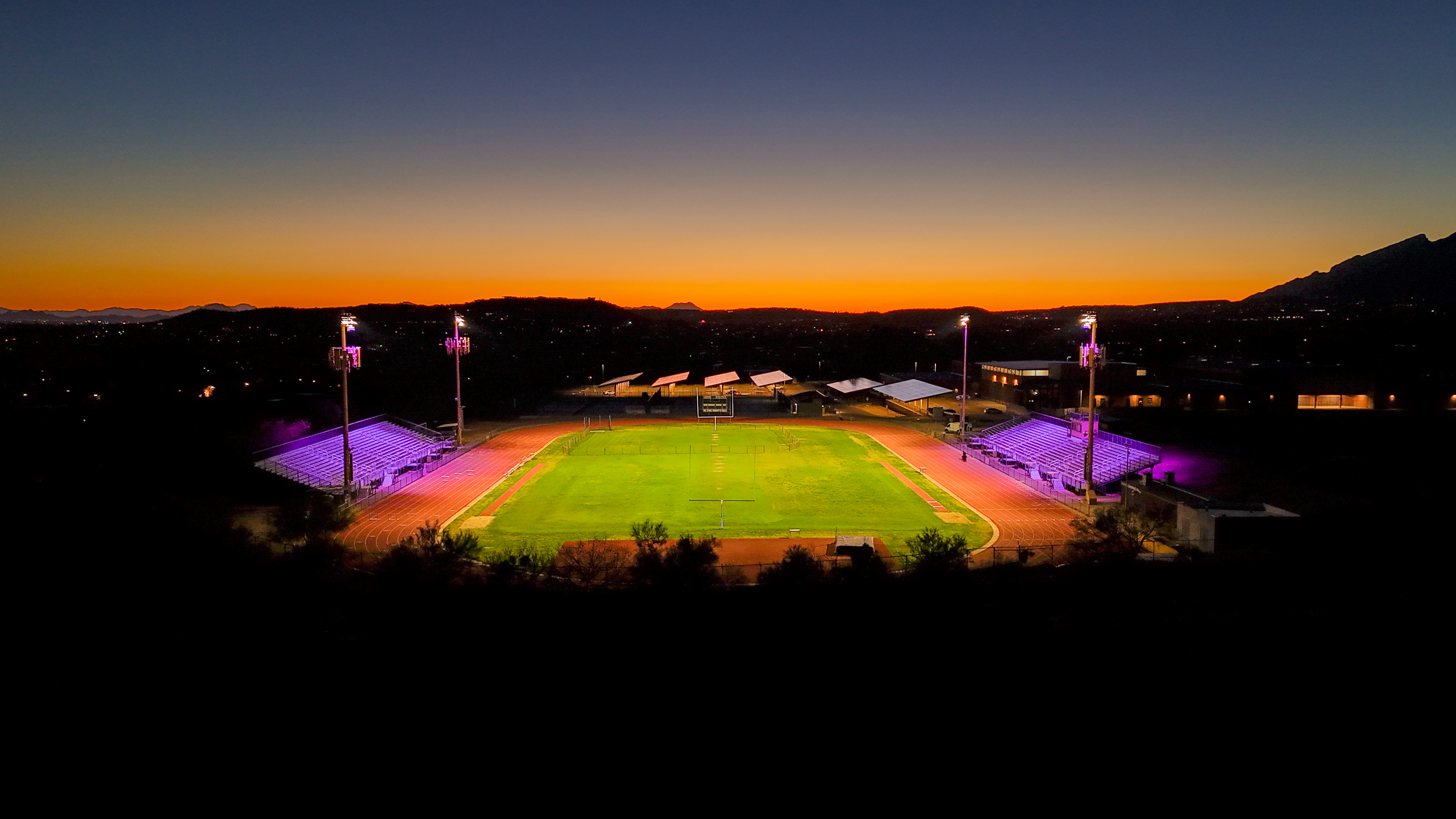 Drone image of Sabino stadium lights at sunset