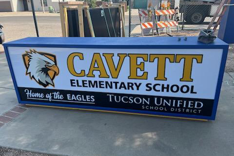 The top of the new marquee for Cavett Elementary School sits on the ground waiting to be installed