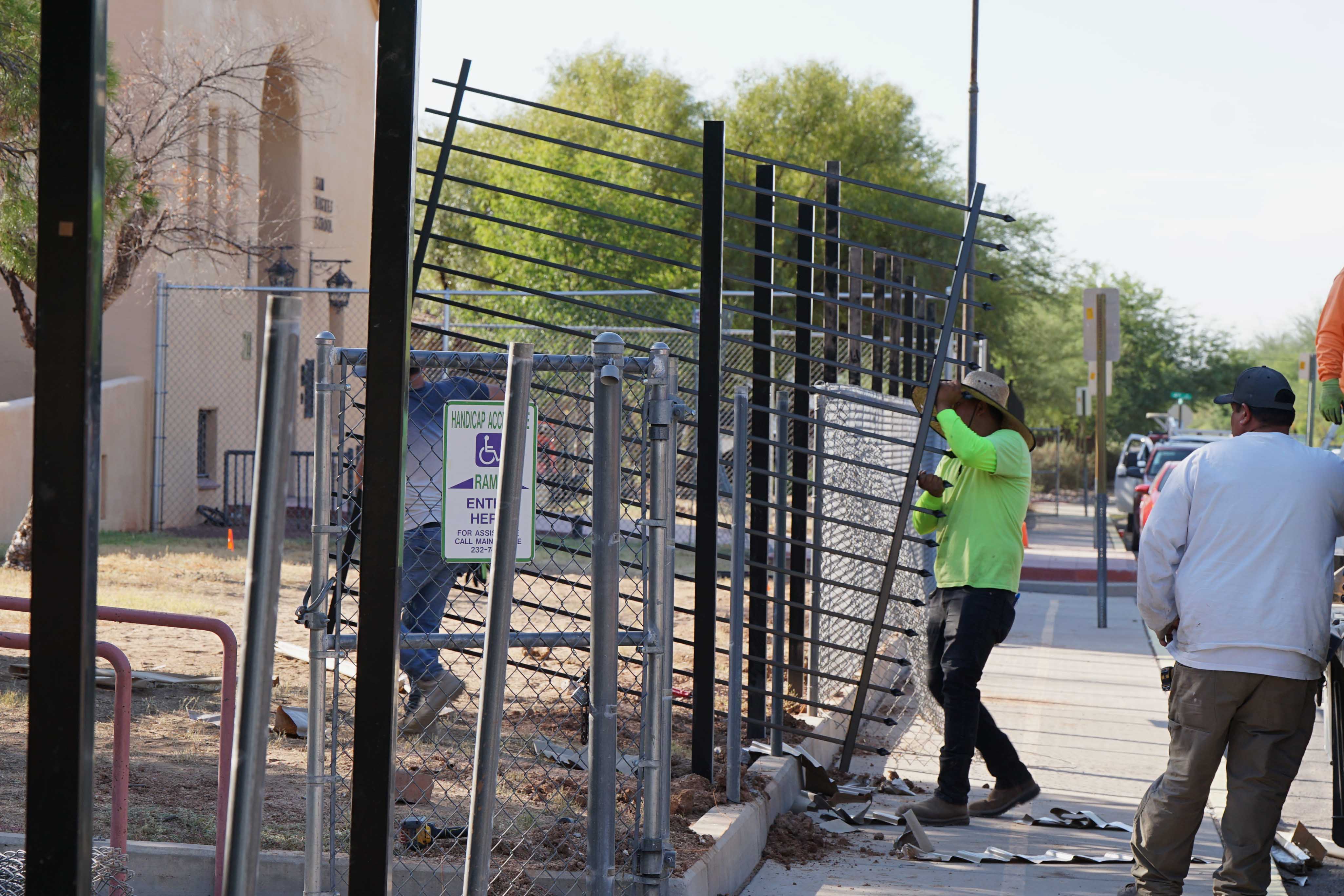 Crews work to install new fencing around Sam Hughes