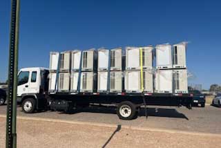 A truck loaded with new air conditioning units